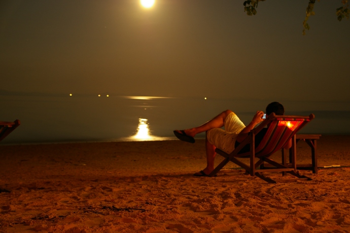 Some guy watches the moon rise over the Andaman Sea
